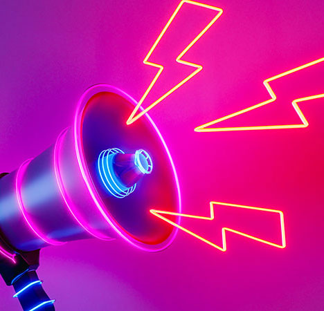 Blitze aus einem neonfarbenen Megafon